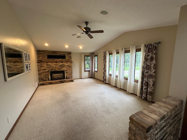 6480 Long Lake Rd, Willmar, MN 56201 - unfurnished living room featuring vaulted ceiling, ceiling fan, carpet, a brick fireplace, and a textured ceiling
