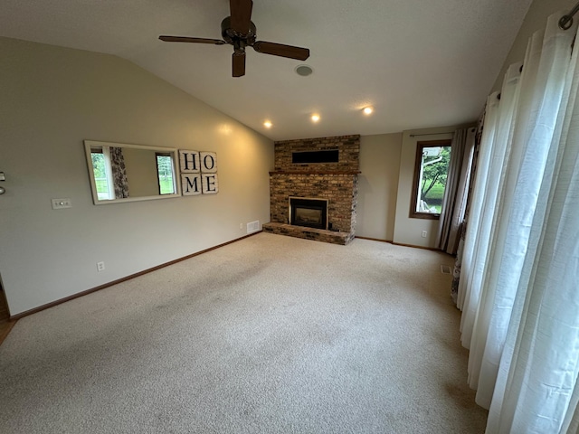 6480 Long Lake Rd, Willmar, MN 56201 - unfurnished living room featuring a ceiling fan, a stone fireplace, lofted ceiling, and light carpet