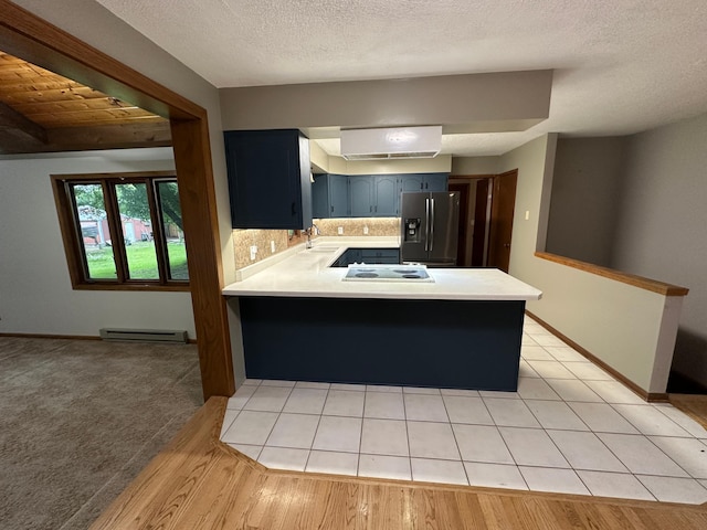 6480 Long Lake Rd, Willmar, MN 56201 - kitchen with stainless steel refrigerator with ice dispenser, a peninsula, light countertops, baseboard heating, and a textured ceiling