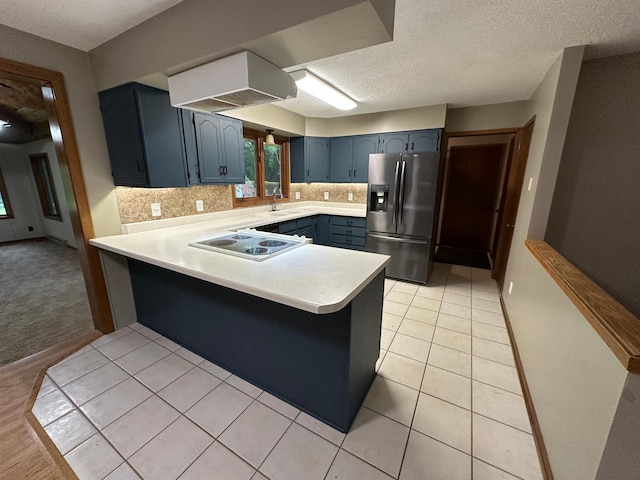 6480 Long Lake Rd, Willmar, MN 56201 - kitchen with stainless steel fridge, electric stovetop, a peninsula, light countertops, and tasteful backsplash