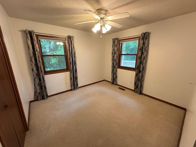 6480 Long Lake Rd, Willmar, MN 56201 - empty room with light carpet, a textured ceiling, and ceiling fan