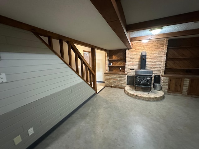 6480 Long Lake Rd, Willmar, MN 56201 - finished below grade area featuring a wood stove, wood walls, and stairs