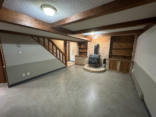 6480 Long Lake Rd, Willmar, MN 56201 - finished below grade area with a wood stove, stairway, and a textured ceiling