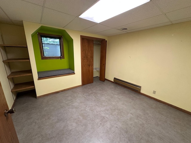 6480 Long Lake Rd, Willmar, MN 56201 - unfurnished bedroom featuring baseboard heating, a drop ceiling, and carpet