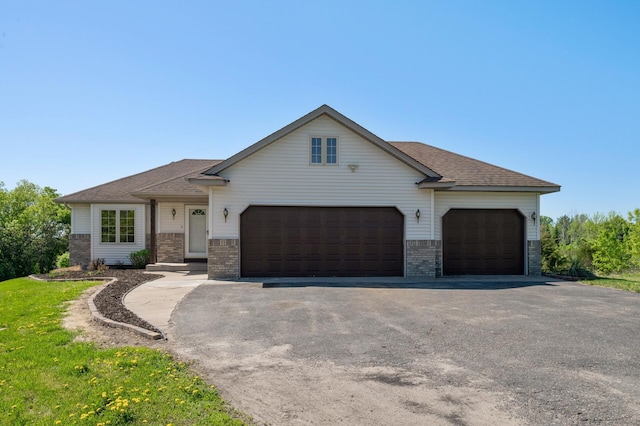 33373 Lakes Trl, Chisago Lake Twp, MN 55045 - view of front of house with an attached garage, asphalt driveway, brick siding, and roof with shingles