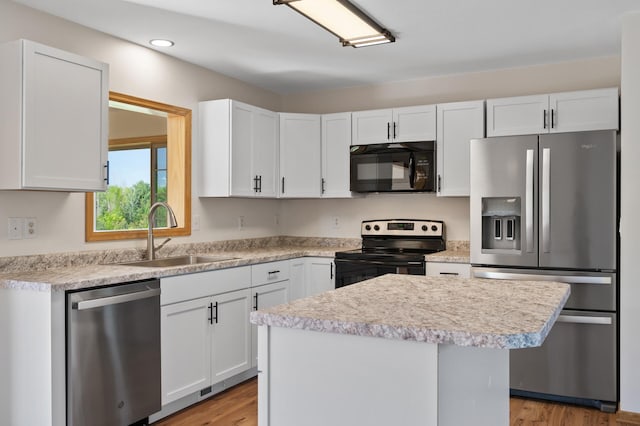 33373 Lakes Trl, Chisago Lake Twp, MN 55045 - kitchen featuring black appliances, a sink, light countertops, white cabinets, and light wood-style flooring