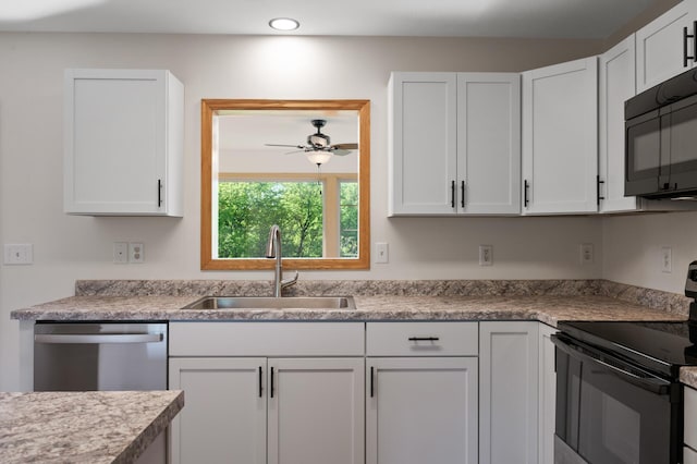 33373 Lakes Trl, Chisago Lake Twp, MN 55045 - kitchen with black appliances, a sink, white cabinetry, recessed lighting, and light countertops