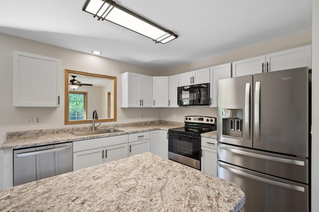 33373 Lakes Trl, Chisago Lake Twp, MN 55045 - kitchen featuring appliances with stainless steel finishes, a sink, white cabinetry, recessed lighting, and light stone countertops