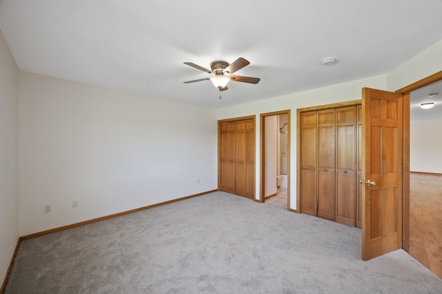 33373 Lakes Trl, Chisago Lake Twp, MN 55045 - unfurnished bedroom featuring two closets, light colored carpet, and baseboards