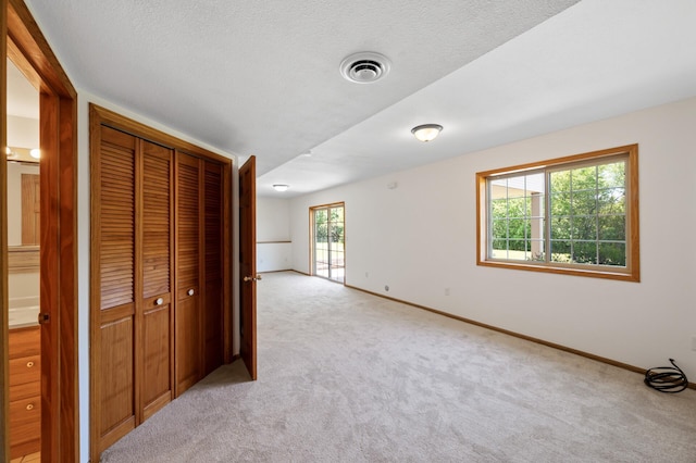 33373 Lakes Trl, Chisago Lake Twp, MN 55045 - unfurnished bedroom featuring light colored carpet, baseboards, a closet, and a textured ceiling