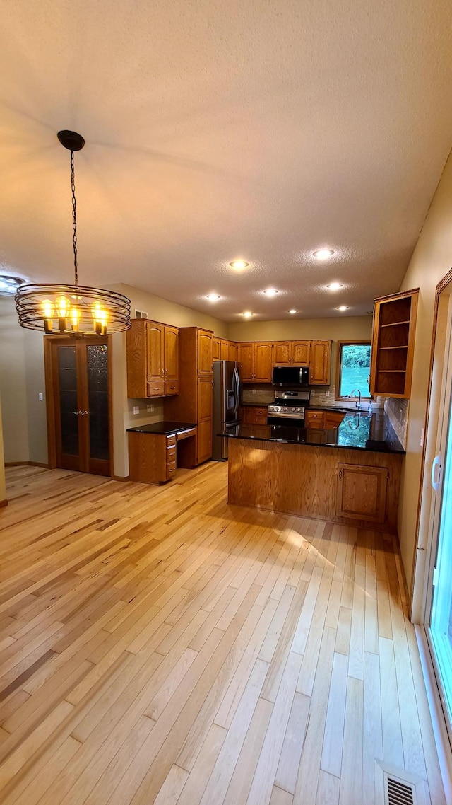 1404 19th Ave NW, Faribault, MN 55021 - kitchen with dark countertops, open shelves, brown cabinetry, stainless steel appliances, and a textured ceiling
