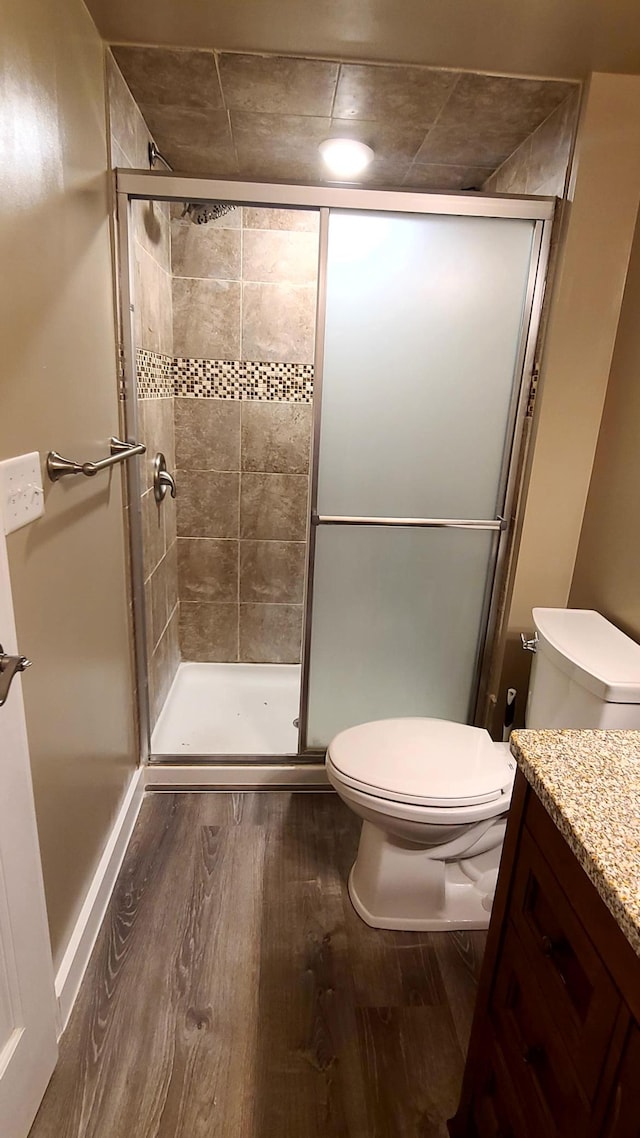 1404 19th Ave NW, Faribault, MN 55021 - bathroom with wood finished floors, vanity, and a shower stall