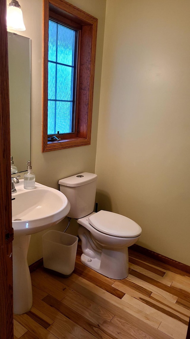 1404 19th Ave NW, Faribault, MN 55021 - bathroom with toilet and wood finished floors