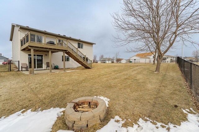 4846 Lionhart Dr NW, Rochester, MN 55901 - snow covered property with a wooden deck, a fire pit, a fenced backyard, and stairway
