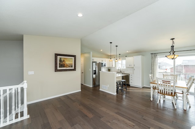 4846 Lionhart Dr NW, Rochester, MN 55901 - dining space with visible vents, baseboards, lofted ceiling, and dark wood-style flooring
