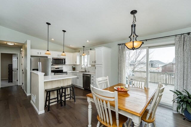 4846 Lionhart Dr NW, Rochester, MN 55901 - dining area with vaulted ceiling, baseboards, and dark wood-type flooring