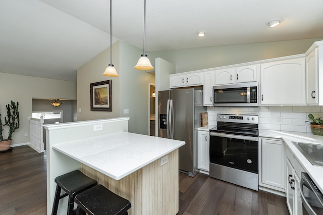 4846 Lionhart Dr NW, Rochester, MN 55901 - kitchen featuring a center island, decorative backsplash, appliances with stainless steel finishes, dark wood-style floors, and white cabinets