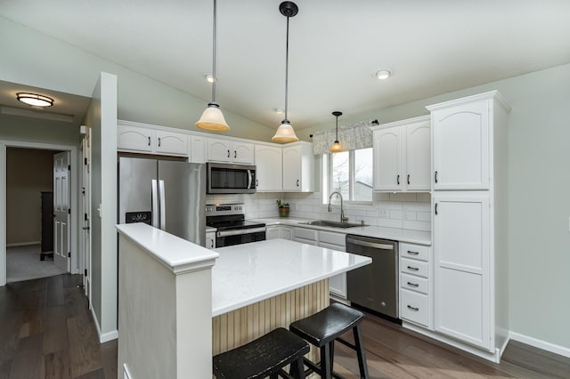 4846 Lionhart Dr NW, Rochester, MN 55901 - kitchen featuring tasteful backsplash, lofted ceiling, stainless steel appliances, white cabinetry, and a sink
