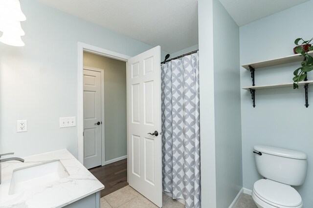4846 Lionhart Dr NW, Rochester, MN 55901 - bathroom featuring baseboards, toilet, a shower with curtain, tile patterned floors, and vanity