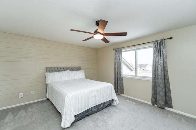 4846 Lionhart Dr NW, Rochester, MN 55901 - carpeted bedroom featuring visible vents, baseboards, wood walls, and a ceiling fan
