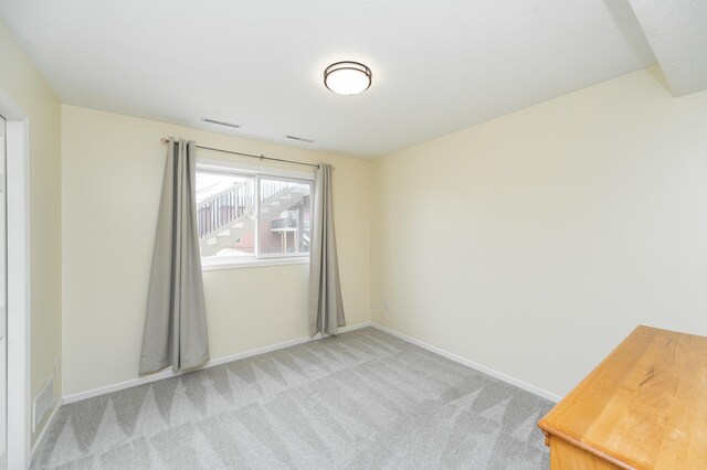 4846 Lionhart Dr NW, Rochester, MN 55901 - spare room featuring visible vents, baseboards, and light colored carpet