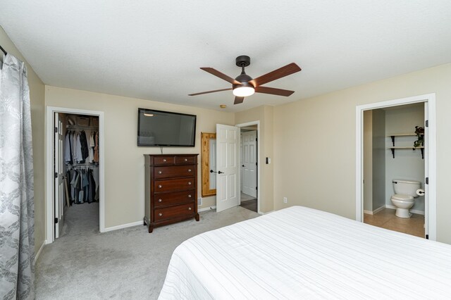 4846 Lionhart Dr NW, Rochester, MN 55901 - bedroom featuring baseboards, ensuite bath, a spacious closet, a closet, and light colored carpet