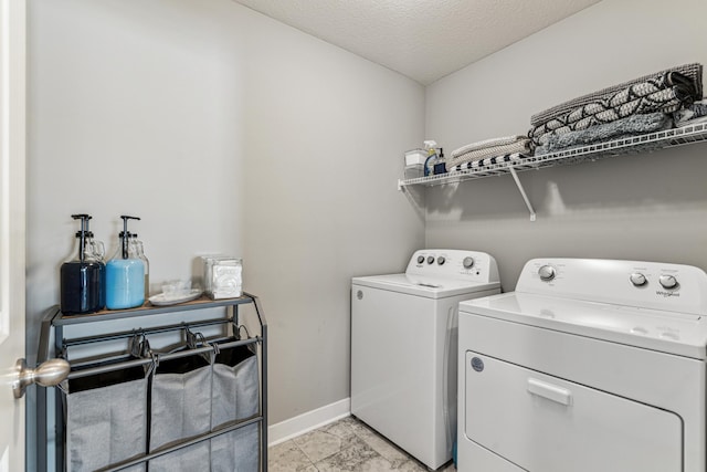 12972 Bauer Dr N, Champlin, MN 55316 - washroom with washing machine and dryer, baseboards, light marble finish floors, and a textured ceiling