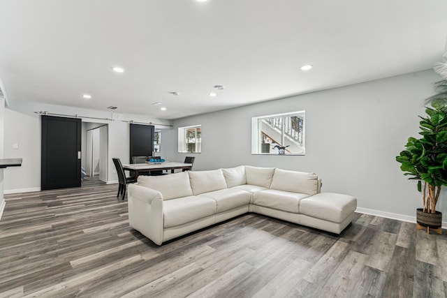 12972 Bauer Dr N, Champlin, MN 55316 - living room featuring a barn door, wood finished floors, recessed lighting, and baseboards