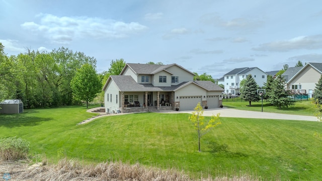 2103 Westgate Dr, Hawley, MN 56549 - view of front of home with an attached garage, a front yard, concrete driveway, a shingled roof, and covered porch