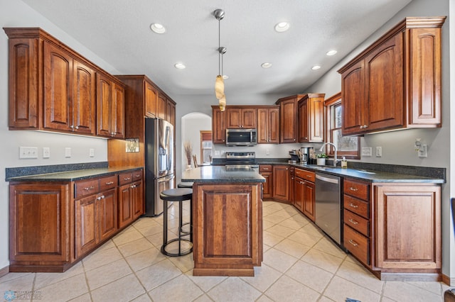 2103 Westgate Dr, Hawley, MN 56549 - kitchen with appliances with stainless steel finishes, a sink, recessed lighting, a kitchen bar, and arched walkways