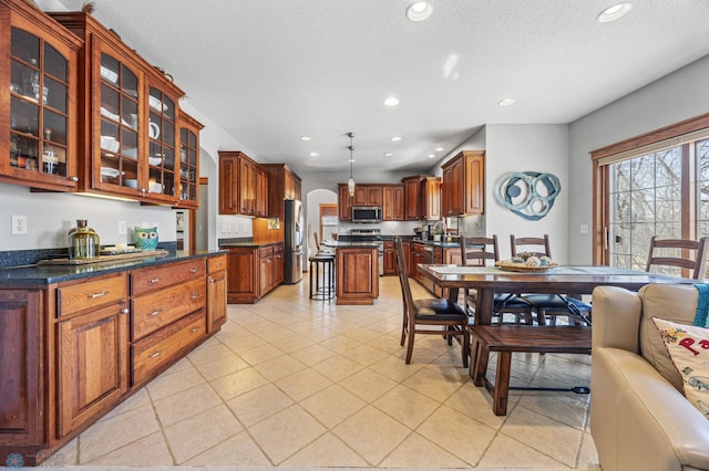 2103 Westgate Dr, Hawley, MN 56549 - dining area with recessed lighting, a textured ceiling, light tile patterned floors, and arched walkways