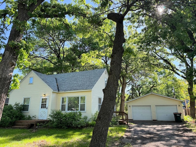 9055 Tyler St NE, Blaine, MN 55434 - view of front of property with a shingled roof, a garage, an outdoor structure, and a deck