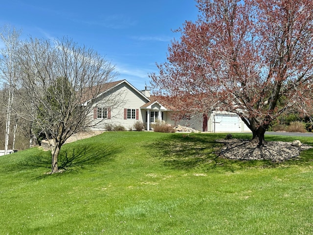 view of front of house with a chimney, driveway, and a front yard