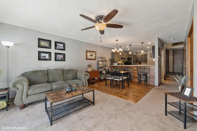 3040 Shields Dr Unit 102, Eagan, MN 55121 - living room featuring ceiling fan, light colored carpet, a textured ceiling, and a chandelier