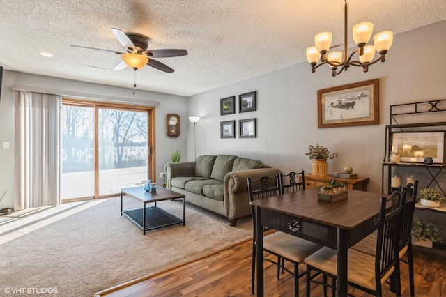3040 Shields Dr Unit 102, Eagan, MN 55121 - living area featuring wood finished floors, a ceiling fan, a textured ceiling, and a chandelier