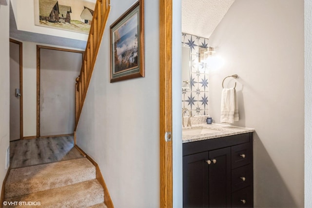 3040 Shields Dr Unit 102, Eagan, MN 55121 - staircase with a textured ceiling and wood finished floors