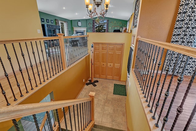 interior space with a fireplace, recessed lighting, and a notable chandelier