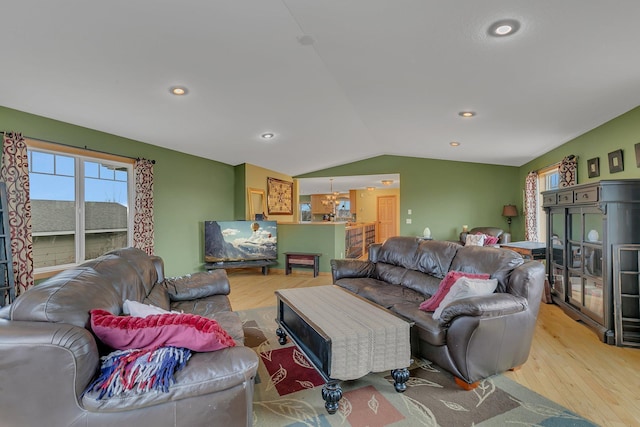 living area with recessed lighting, light wood-style floors, and vaulted ceiling