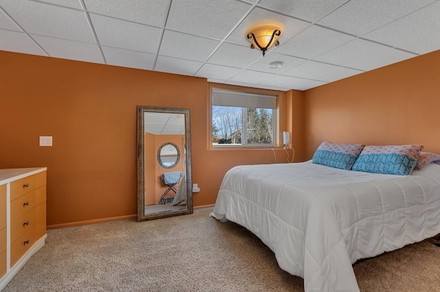 bedroom with baseboards, carpet, and a paneled ceiling