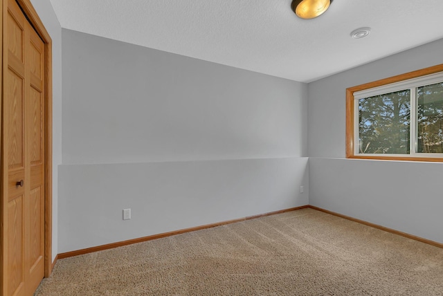unfurnished bedroom featuring carpet, a closet, and baseboards