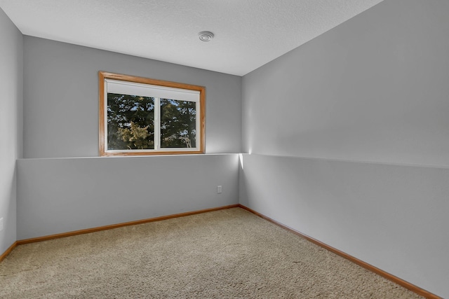 carpeted spare room with baseboards