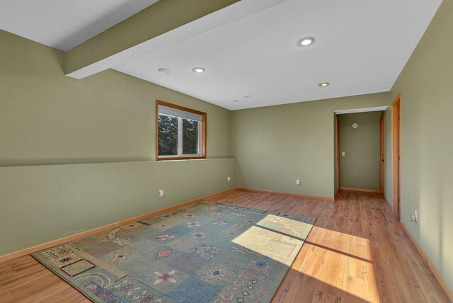 spare room featuring wood finished floors, recessed lighting, and baseboards
