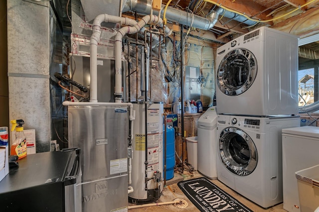 laundry room featuring stacked washer and clothes dryer, water heater, and laundry area