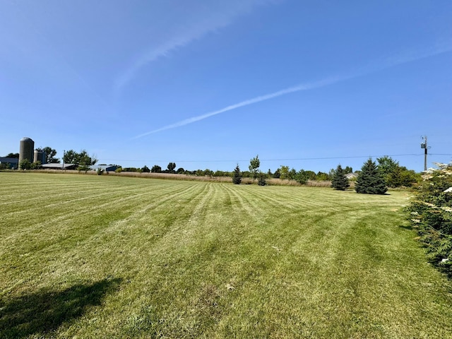view of yard with a rural view