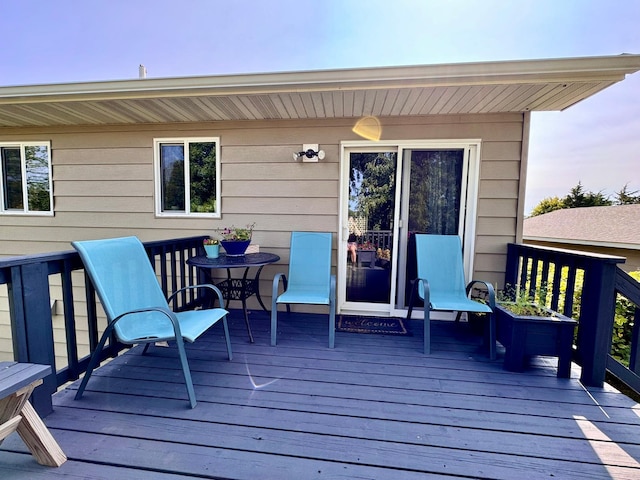 wooden terrace featuring outdoor dining area