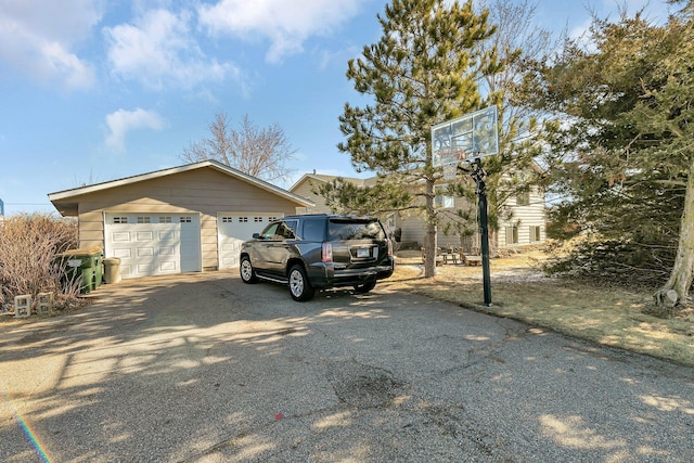view of side of home featuring an outdoor structure and driveway