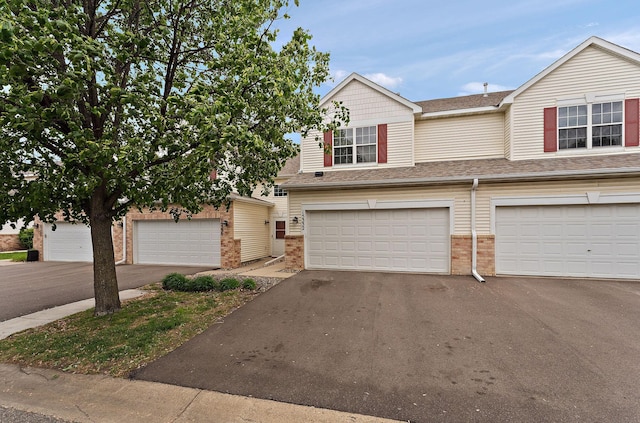 15332 Floret Way, Apple Valley, MN 55124 - view of front of property with brick siding, asphalt driveway, an attached garage, and roof with shingles