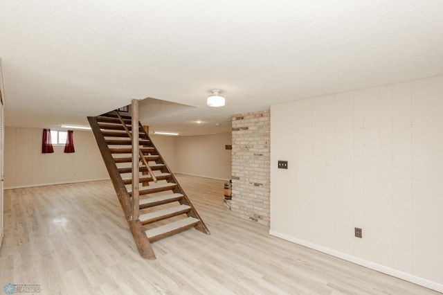 301 3rd Ave S, Borup, MN 56519 - basement with baseboards, stairway, and light wood-type flooring
