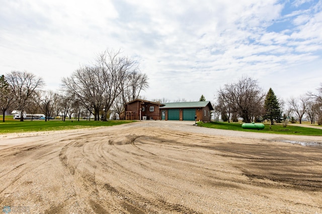 301 3rd Ave S, Borup, MN 56519 - log cabin with an outbuilding and dirt driveway