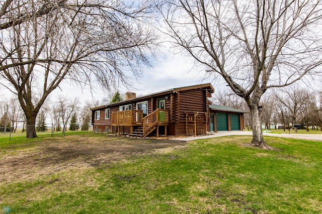 301 3rd Ave S, Borup, MN 56519 - view of front of home with a garage, a front yard, a deck, a chimney, and log exterior